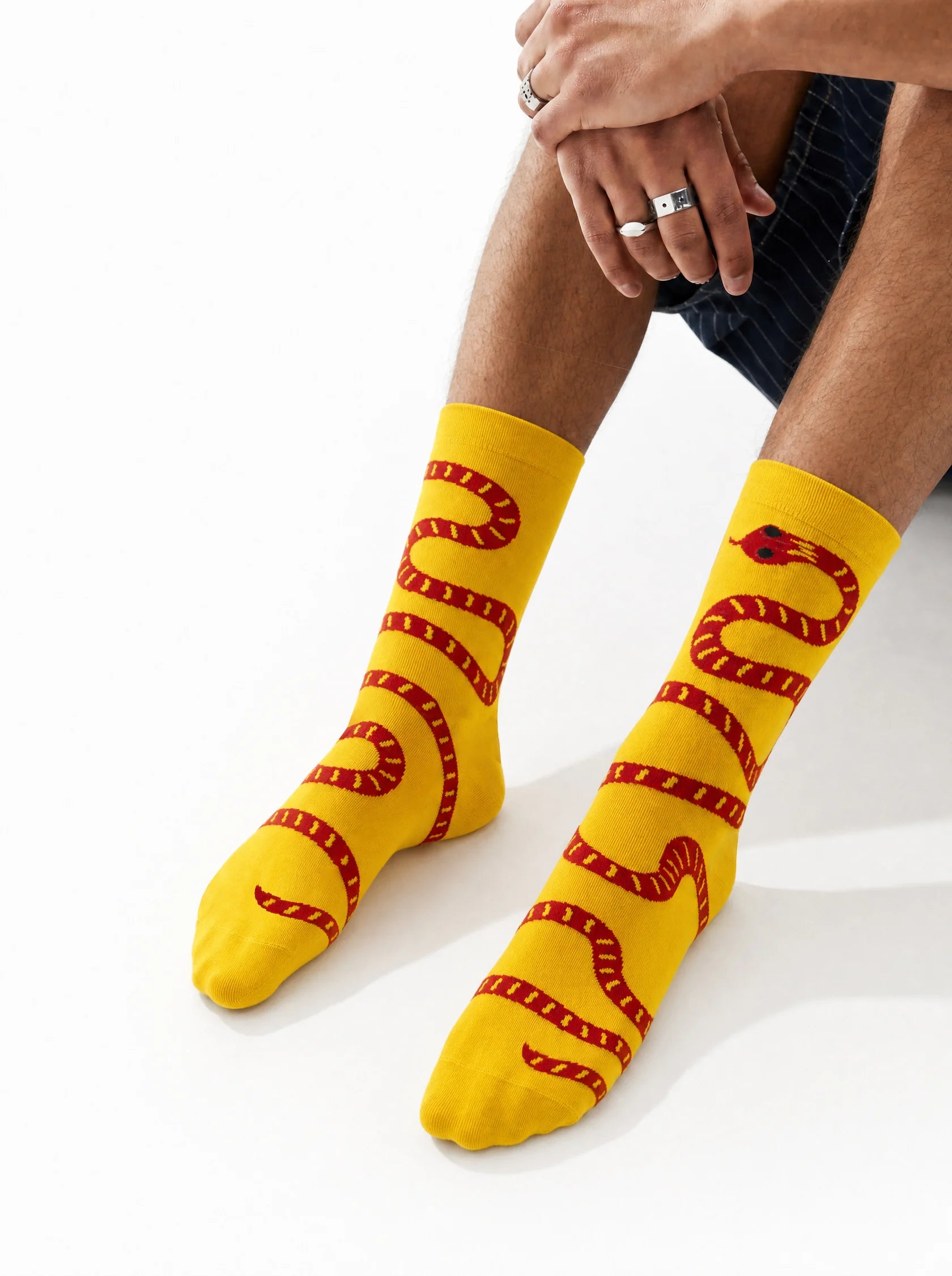 Women's yellow crew socks with red snake design - front view