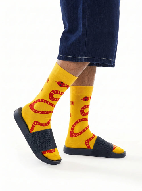 Men's yellow crew socks with red snake design - side view 1